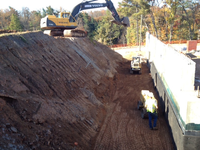 Crews are backfilling and compacting the lower level walls of a commercial project  in Asheville, N.C.