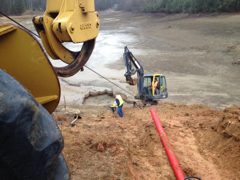 This crew is installing a permanent siphon drain in a lake near Brevard, N.C.