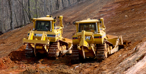 The rippers on the back of the larger bulldozers are used to tear out rock and hard soils.